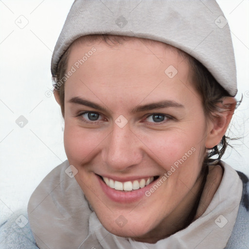 Joyful white young-adult female with short  brown hair and blue eyes