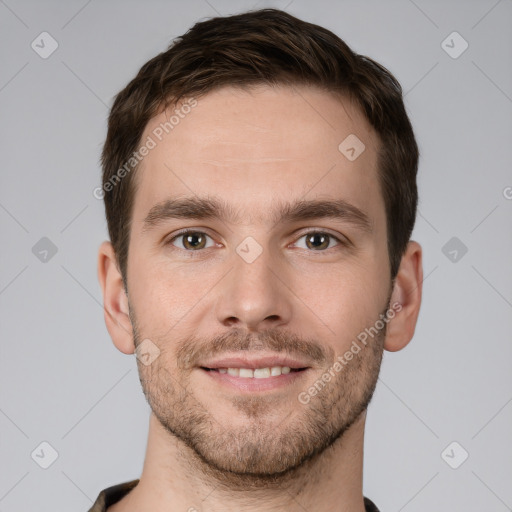 Joyful white young-adult male with short  brown hair and grey eyes