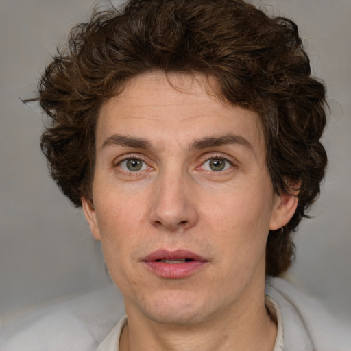 Joyful white adult male with medium  brown hair and green eyes