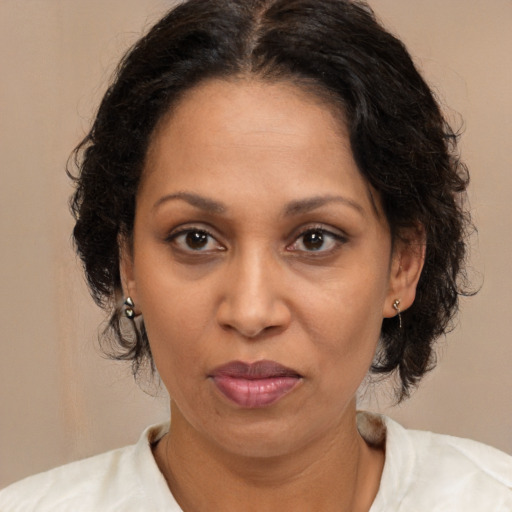 Joyful black adult female with medium  brown hair and brown eyes