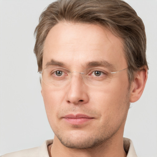 Joyful white adult male with short  brown hair and grey eyes