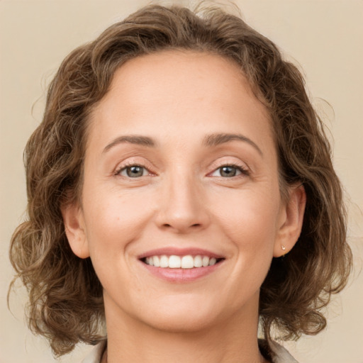 Joyful white young-adult female with medium  brown hair and green eyes