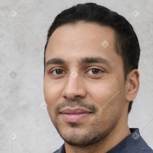 Joyful white young-adult male with short  black hair and brown eyes