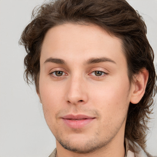 Joyful white young-adult male with medium  brown hair and brown eyes