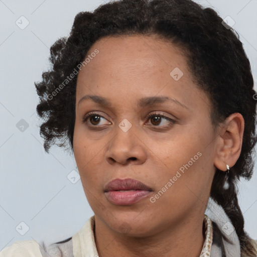 Joyful black adult female with short  brown hair and brown eyes