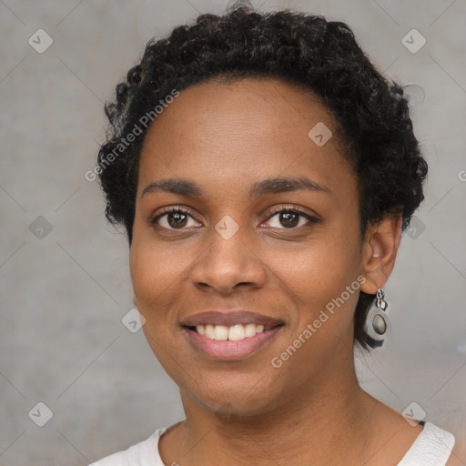 Joyful black young-adult female with short  black hair and brown eyes