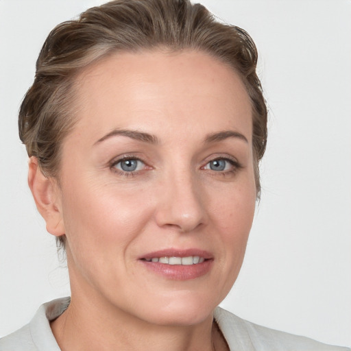 Joyful white adult female with medium  brown hair and grey eyes