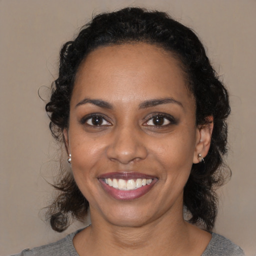 Joyful black young-adult female with medium  black hair and brown eyes