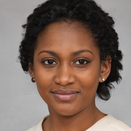 Joyful black young-adult female with medium  black hair and brown eyes