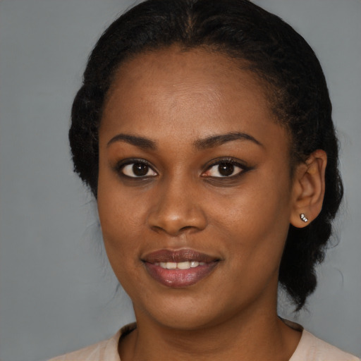 Joyful black young-adult female with medium  brown hair and brown eyes