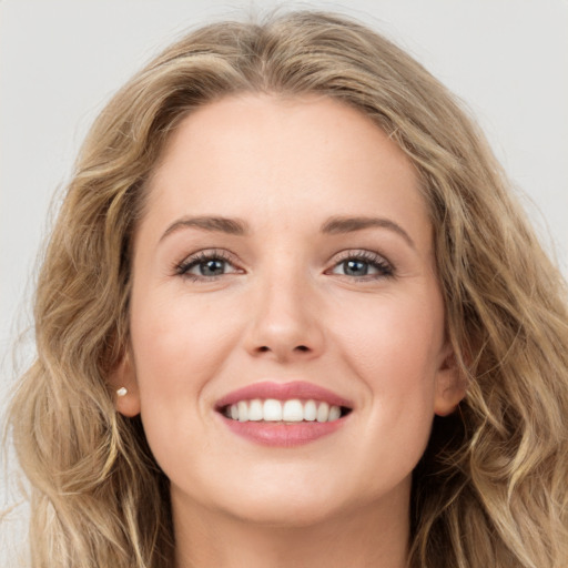 Joyful white young-adult female with long  brown hair and green eyes