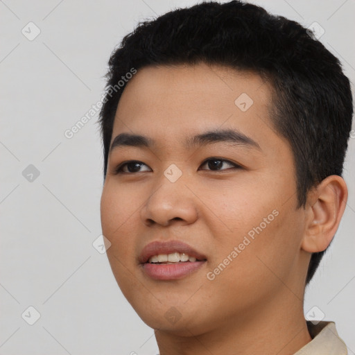 Joyful asian young-adult male with short  black hair and brown eyes