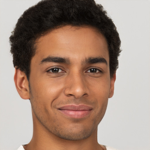 Joyful latino young-adult male with short  brown hair and brown eyes