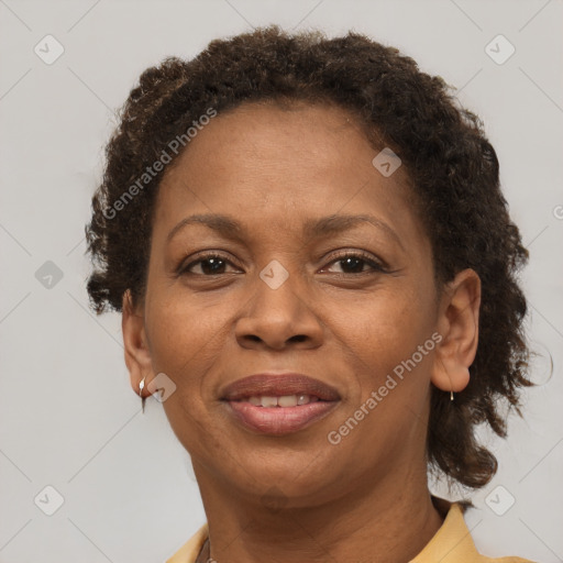 Joyful black adult female with short  brown hair and brown eyes