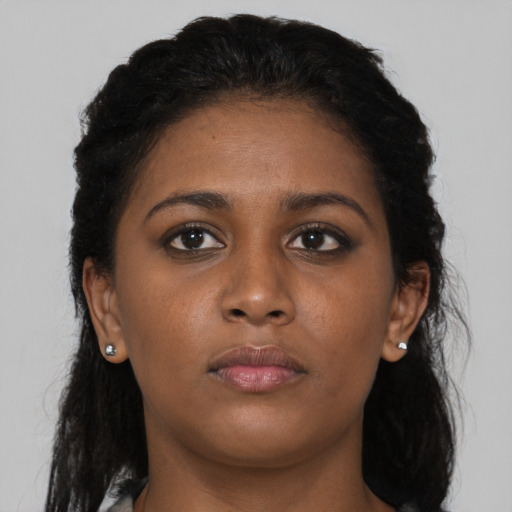 Neutral black young-adult female with long  brown hair and brown eyes