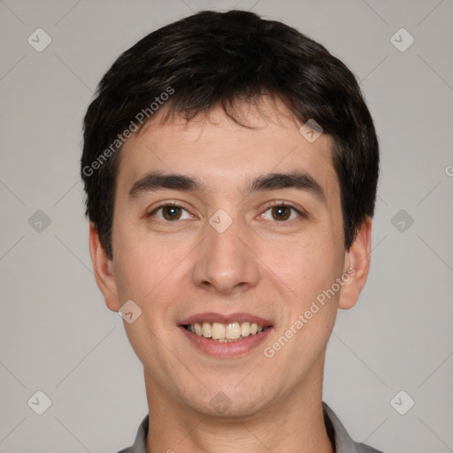 Joyful white young-adult male with short  black hair and brown eyes