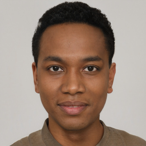 Joyful black young-adult male with short  black hair and brown eyes