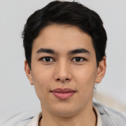 Joyful asian young-adult male with short  black hair and brown eyes