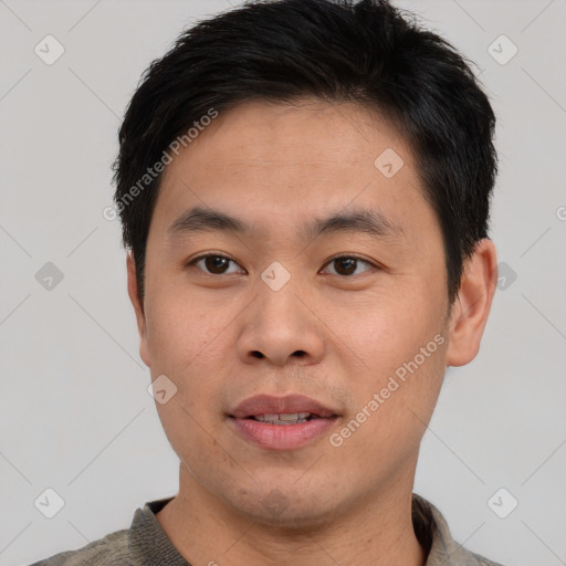 Joyful asian young-adult male with short  black hair and brown eyes