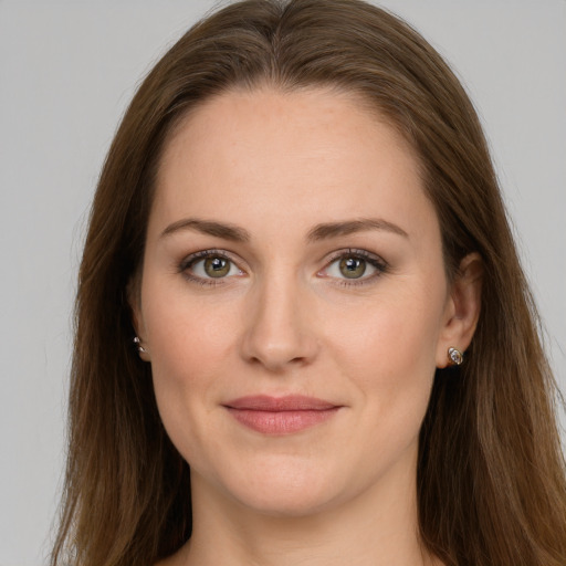 Joyful white young-adult female with long  brown hair and grey eyes