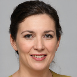 Joyful white adult female with medium  brown hair and grey eyes