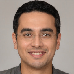 Joyful white young-adult male with short  black hair and brown eyes
