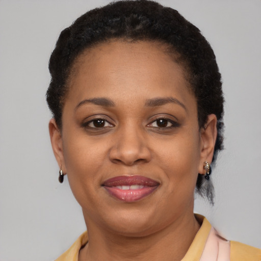 Joyful latino adult female with short  brown hair and brown eyes