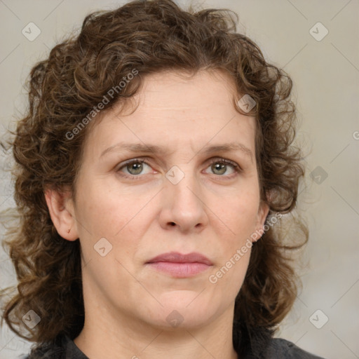 Joyful white adult female with medium  brown hair and green eyes