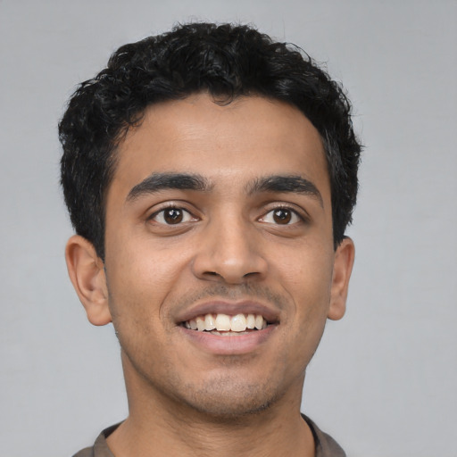 Joyful latino young-adult male with short  black hair and brown eyes