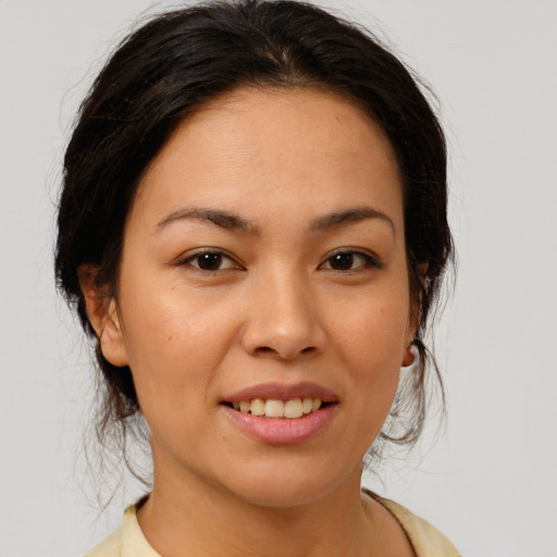 Joyful asian young-adult female with medium  brown hair and brown eyes