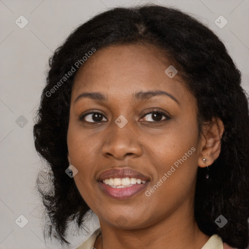 Joyful black adult female with medium  brown hair and brown eyes