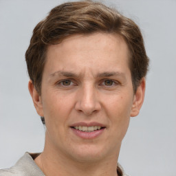 Joyful white adult male with short  brown hair and grey eyes