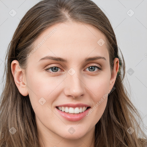 Joyful white young-adult female with long  brown hair and blue eyes