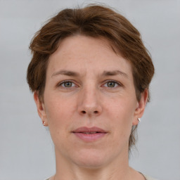 Joyful white adult female with short  brown hair and grey eyes