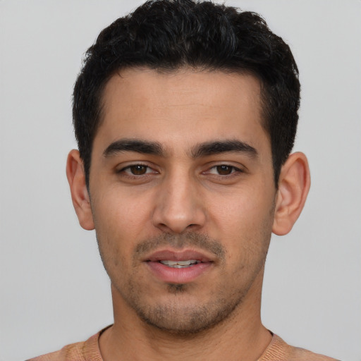 Joyful white young-adult male with short  black hair and brown eyes