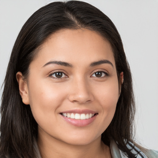 Joyful white young-adult female with long  brown hair and brown eyes