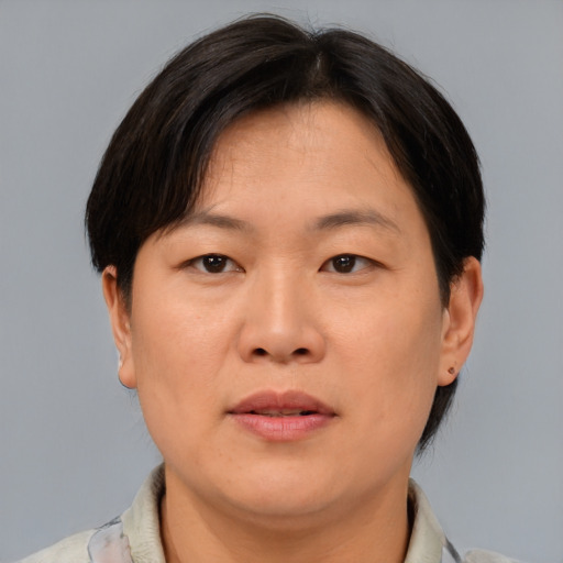 Neutral asian adult female with short  brown hair and brown eyes