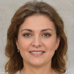 Joyful white young-adult female with medium  brown hair and green eyes