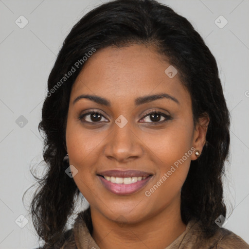 Joyful black young-adult female with long  brown hair and brown eyes