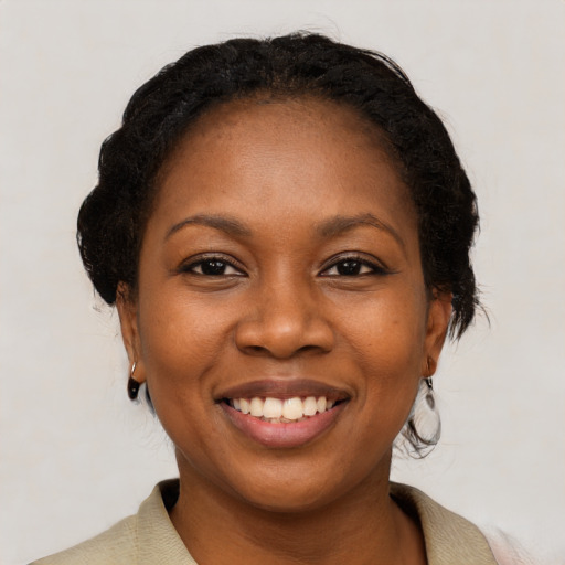 Joyful black young-adult female with medium  brown hair and brown eyes
