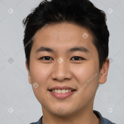 Joyful asian young-adult male with short  brown hair and brown eyes