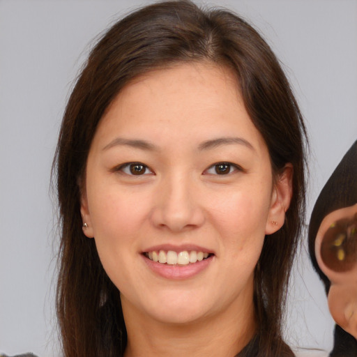 Joyful white young-adult female with long  brown hair and brown eyes