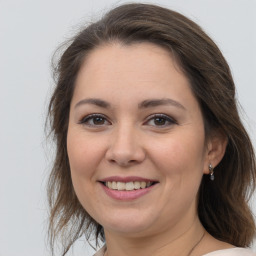 Joyful white adult female with medium  brown hair and brown eyes