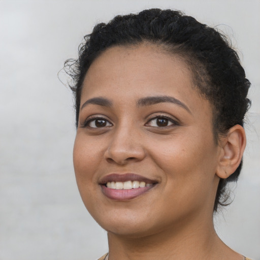 Joyful latino young-adult female with medium  brown hair and brown eyes