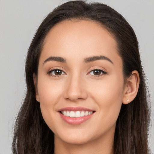 Joyful white young-adult female with long  brown hair and brown eyes