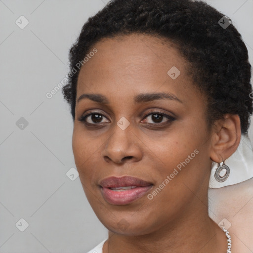 Joyful black young-adult female with short  black hair and brown eyes