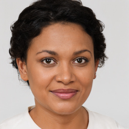 Joyful black young-adult female with short  brown hair and brown eyes