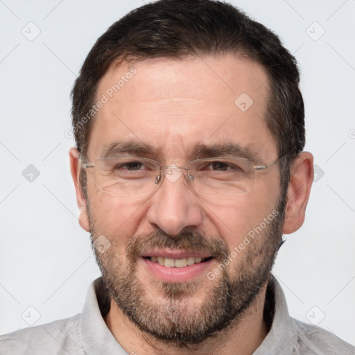 Joyful white adult male with short  brown hair and brown eyes