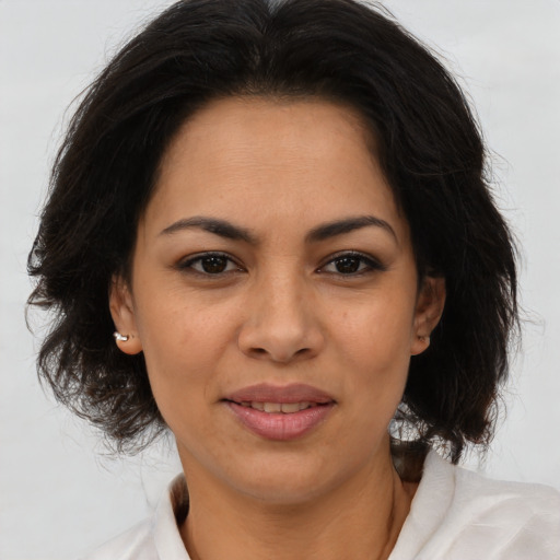Joyful latino young-adult female with medium  brown hair and brown eyes