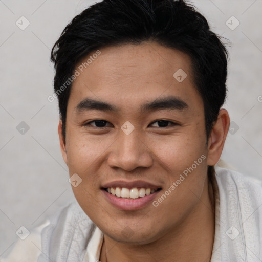 Joyful asian young-adult male with short  black hair and brown eyes